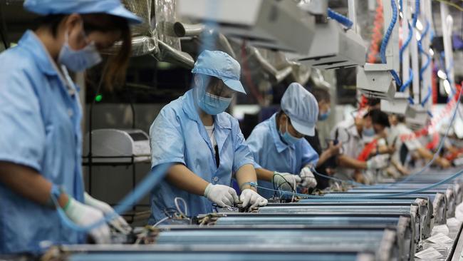 Employees work on an air conditioner production line in Wuhan. Picture: AFP