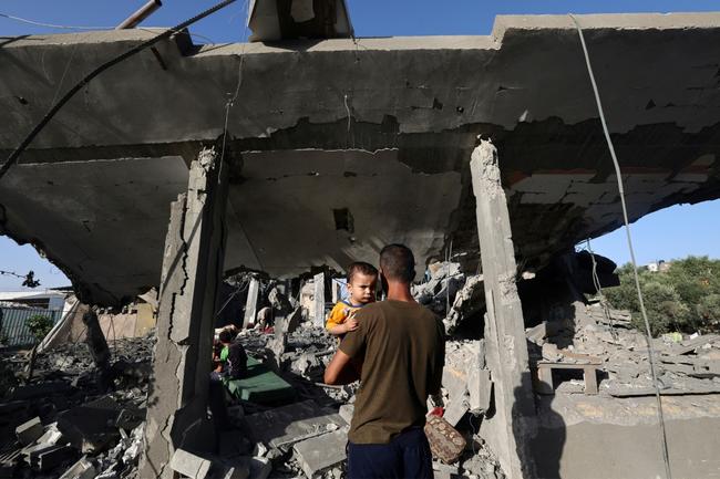 Palestinians gather at a food kitchen in Nuseirat refugee camp in central Gaza.