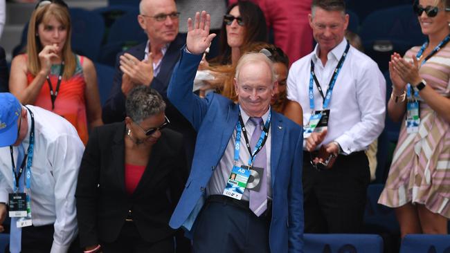 Rod Laver waves to the crowd as he takes in the action on day 10. Picture: AFP