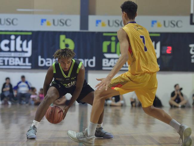 Queensland State Basketball Titles at USC Stadium.USC Rip City against Pirates.Rip City player Ronnie Twidale looks for space.