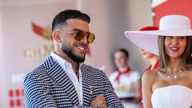 Adrian Portelli, pictured with partner Karlie Butler at the 2024 Melbourne Cup, is best known for his publicity stunts and love of fast cars. Picture: Jason Edwards