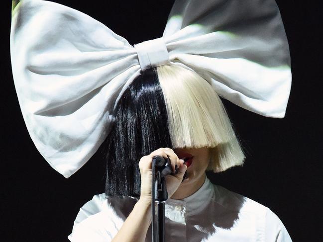 Singer Sia performs on stage during an Apple event at Bill Graham Civic Auditorium in San Francisco, California on September 07, 2016.  / AFP PHOTO / Josh Edelson