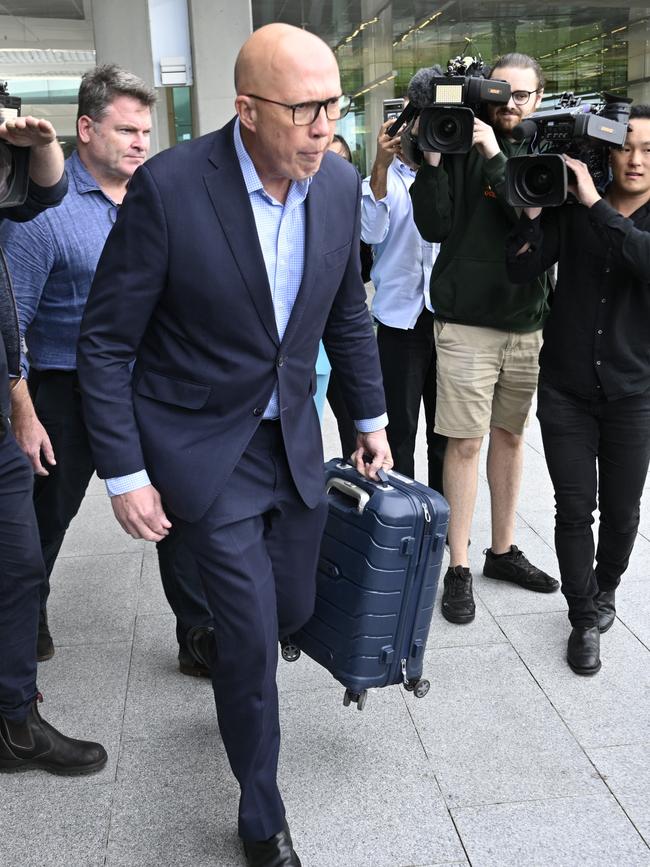 The ousted Opposition Leader was seen putting his suitcase in the boot of a waiting Commonwealth car himself. Picture: NewsWire / Martin Ollman