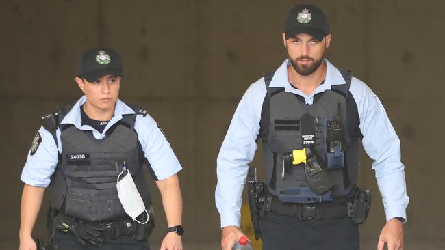 AFP officers leaving the rear doors of the CFMEU building in Bulwara Road, Pyrmont. Picture: John Grainger