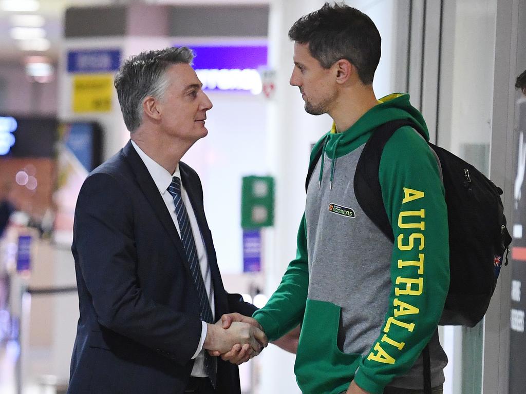 Anthony Moore speaks with Daniel Kickert at Brisbane Airport. Picture: AAP