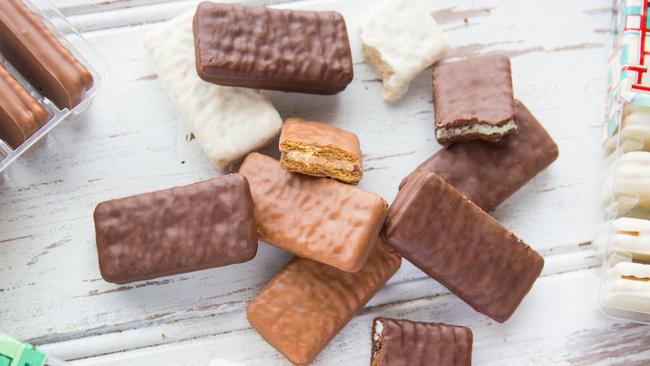 The woman removed Tim Tams and other snacks from her pants.