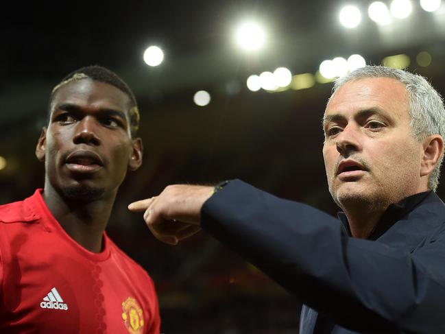 Manchester United's Portuguese manager Jose Mourinho (R) gestures to Manchester United's French midfielder Paul Pogba as he arrives on the pitch ahead of the UEFA Europa League group A football match between Manchester United and Zorya Luhansk at Old Trafford stadium in Manchester, north-west England, on September 29, 2016. / AFP PHOTO / PAUL ELLIS