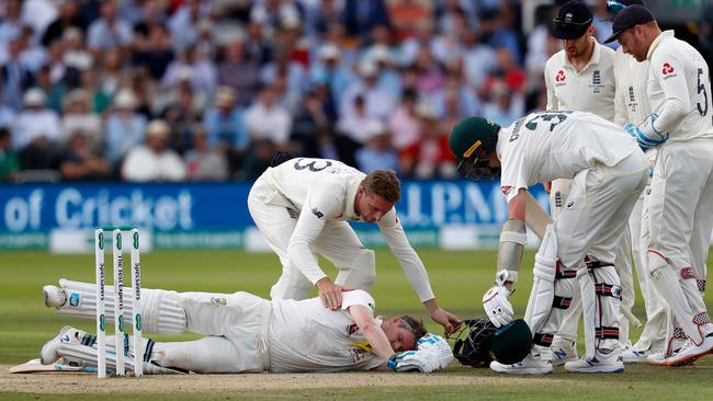 Players rush to assist Australian batsman Steve Smith after he was hit in the neck by a ball off the bowling of England's Jofra Archer.