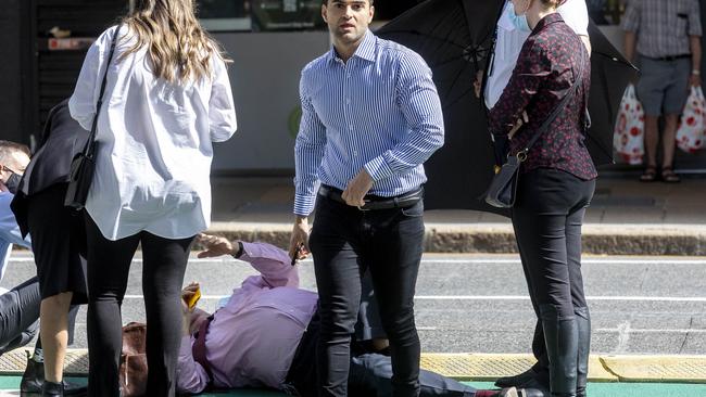 Ali Ebrahimi checks on his barrister Peter Nolan after he fell outside of the Brisbane District Court. Picture: NCA NewsWire / Sarah Marshall