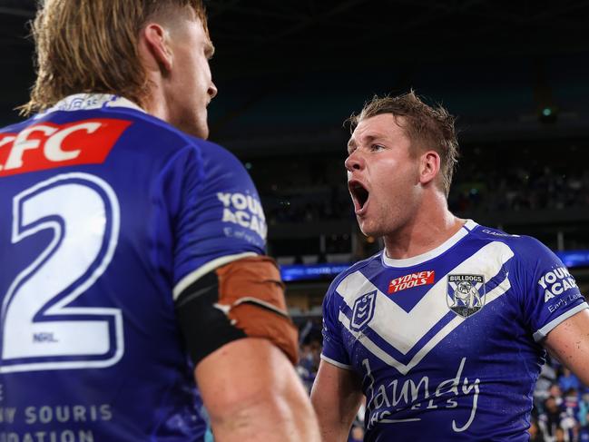 SYDNEY, AUSTRALIA - APRIL 02: Matt Burton of the Bulldogs celebrates with Jacob Preston of the Bulldogs after kicking the winning field goal in extra time during the round five NRL match between Canterbury Bulldogs and North Queensland Cowboys at Accor Stadium on April 02, 2023 in Sydney, Australia. (Photo by Cameron Spencer/Getty Images)
