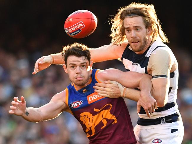 Lachie Neale (left) of the Lions contests for the ball against Cameron Guthrie (right) of the Cats during the Round 22 AFL match between the Brisbane Lions and the Geelong Cats at the Gabba in Brisbane, Saturday, August 17, 2019.  (AAP Image/Darren England) NO ARCHIVING, EDITORIAL USE ONLY