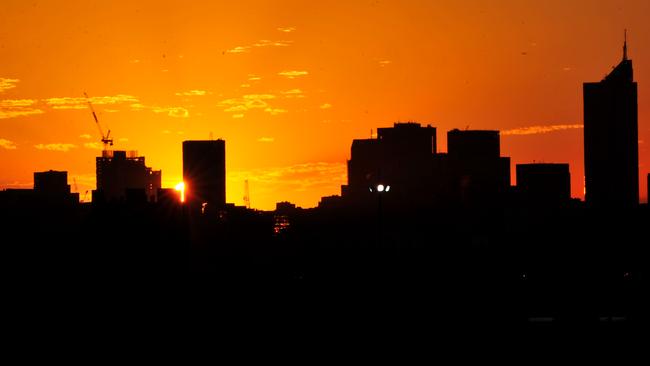 The sun rises over Melbourne.