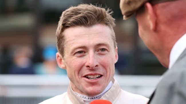 MELBOURNE, AUSTRALIA - OCTOBER 19: Jockey Harry Coffey is interviewed after riding Duke De Sessa to win race 9 the Sportsbet Caulfield Cup during Melbourne Racing at Caulfield Racecourse on October 19, 2024 in Melbourne, Australia. (Photo by Kelly Defina/Getty Images)