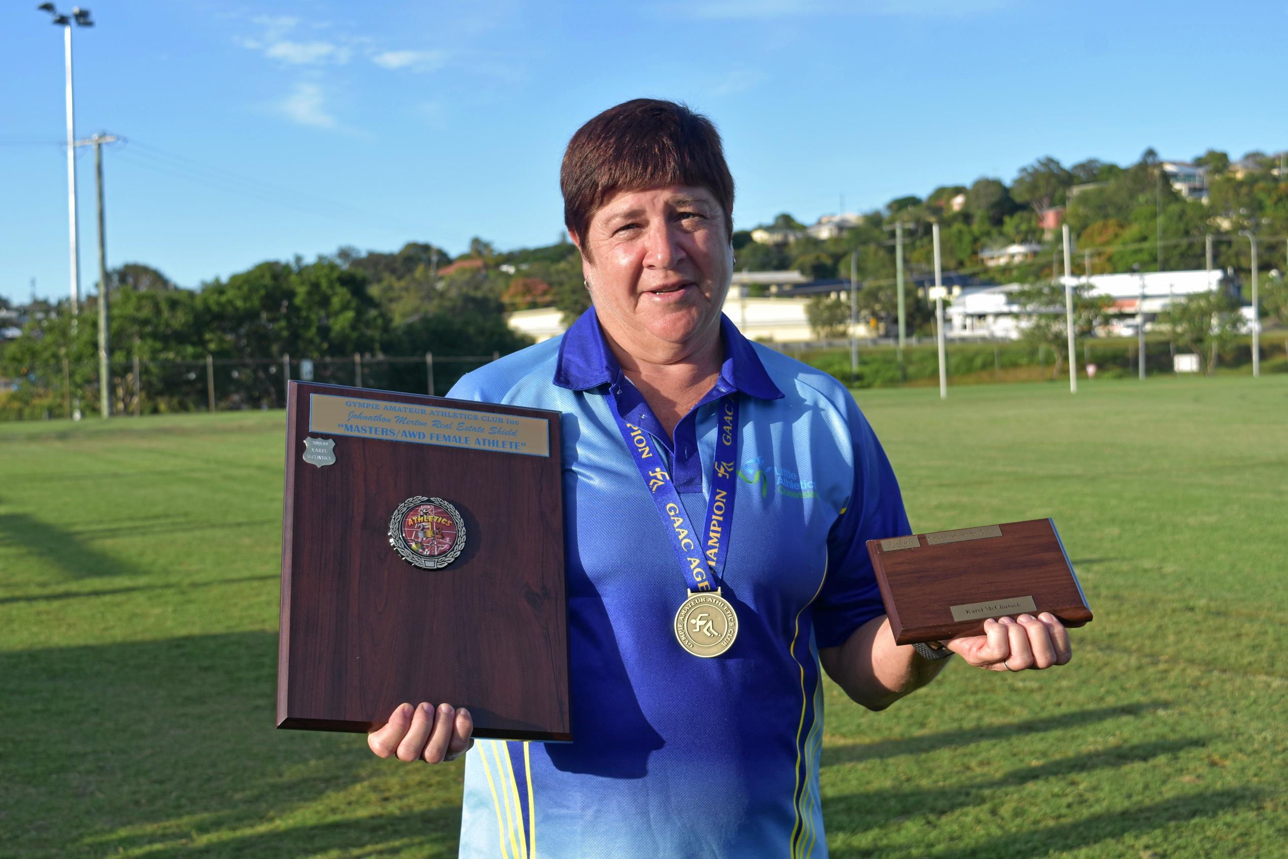 Athletics - Johnathan Merton Real Estate Shield for Masters/AWD Female Athlete and under 60 female age champion Karel McClintock. Picture: Bec Singh