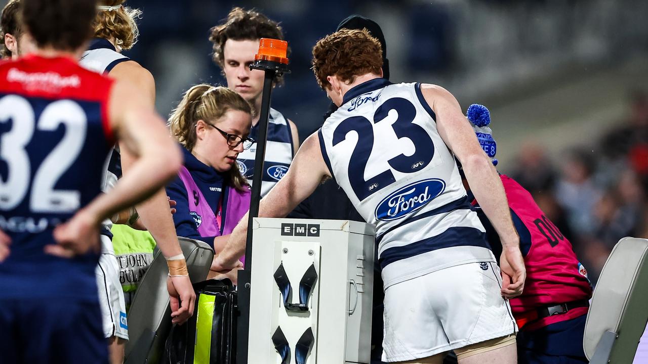GEELONG, AUSTRALIA - JUNE 22: Gary Rohan of the Cats consoles his teammate Jeremy Cameron who is on the medical cart during the 2023 AFL Round 15 match between the Geelong Cats and the Melbourne Demons at GMHBA Stadium on June 22, 2023 in Geelong, Australia. (Photo by Dylan Burns/AFL Photos via Getty Images)