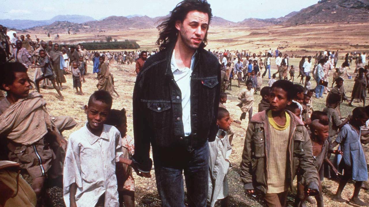 Singer Bob Geldof with children in Ethiopia for Live Aid in 1985.