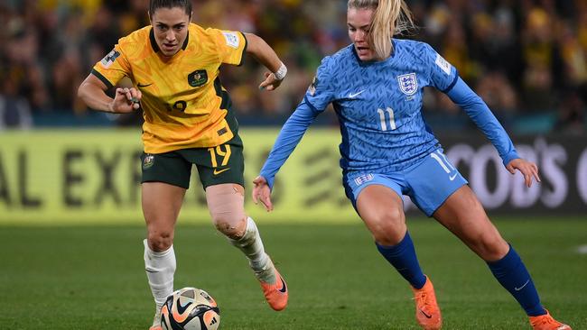 Australia's midfielder Katrina Gorry fights for the ball with England's forward Lauren Hemp during semi-final football match at Stadium Australia in Sydney. Picture: FRANCK FIFE / AFP