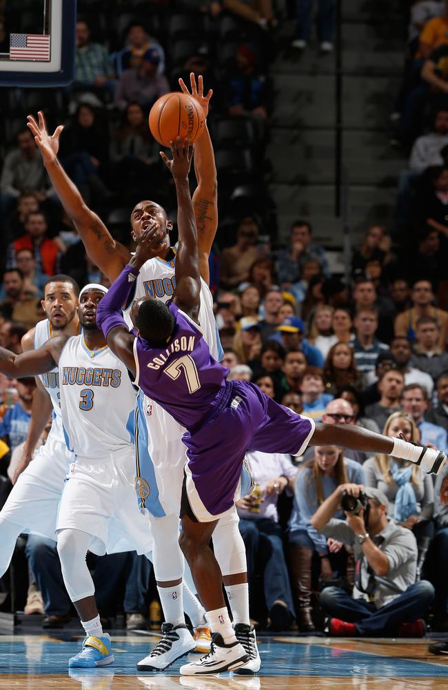 The Kings’ Darren Collison is fouled by Darrell Arthur of the Nuggets.