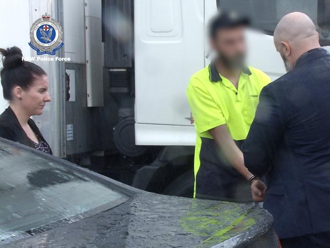 One of the men being escorted by police on January 16, 2020. Picture: NSW Police