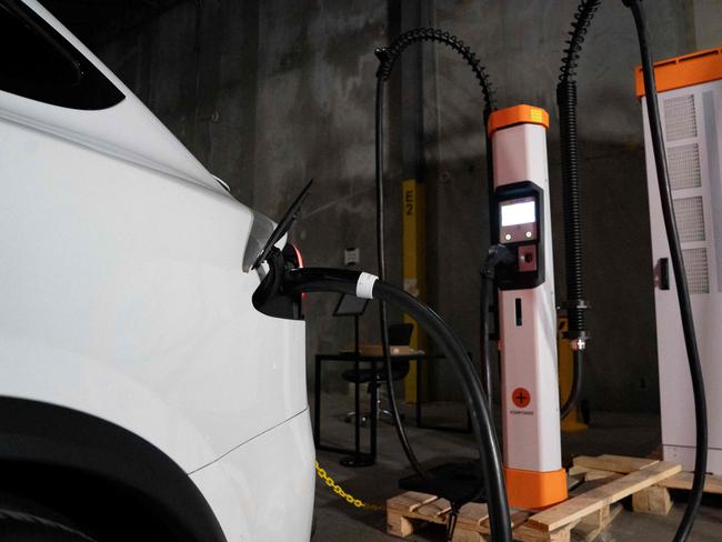 A car charges at EV fast-charger manufacturer Kempower on April 23, 2024, in Durham, North Carolina. The United States is seeing an investment surge as President Joe Biden pushes to rebuild "hollowed out" industrial communities and grow domestic supply chains in key sectors like electric vehicles (EVs), batteries and semiconductors. A new "battery belt" has taken shape, largely across the southeast including North Carolina and Georgia, as factories for EV batteries and components emerge. (Photo by Allison Joyce / AFP)