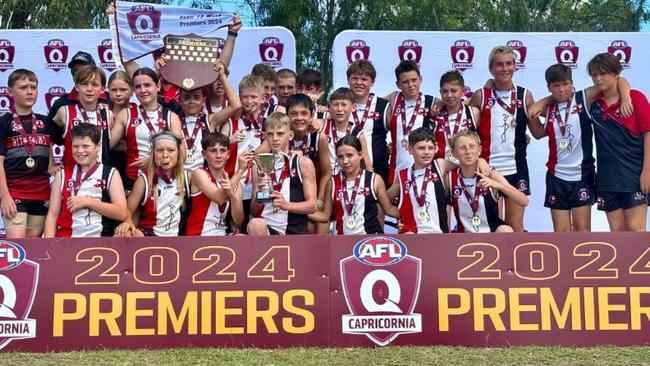 BITS Saints celebrate their premiership win in the AFL Capricornia under-13 mixed grand final.