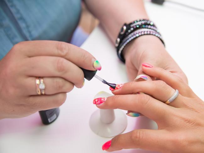 Generic pic of woman in salon receiving manicure by nail technician. Pic: iStock