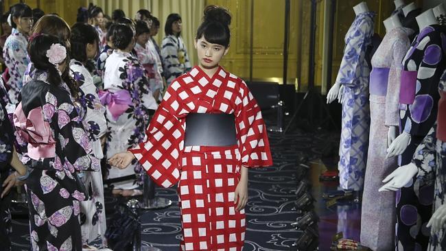 A model displays a traditional Japanese yukata during a Tokyo festival event.