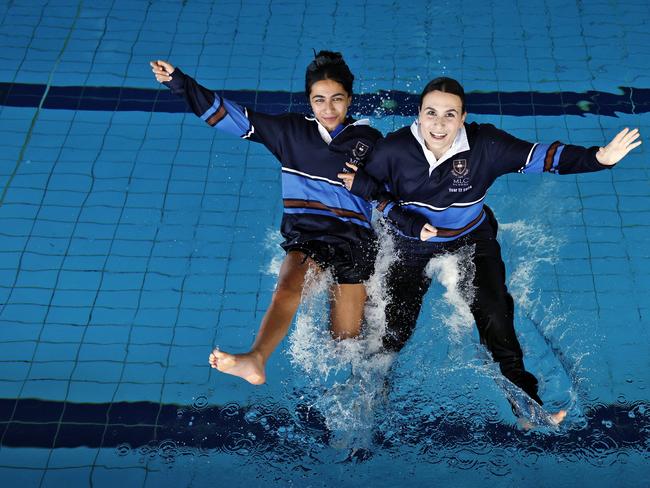 DAILY TELEGRAPH - 8/11/24, HSC finishers Mira Kalra and Sophia Pavlovic (right) pictured jumping into the school pool at MLC Burwood today after the final exam for the state. Picture: Sam Ruttyn