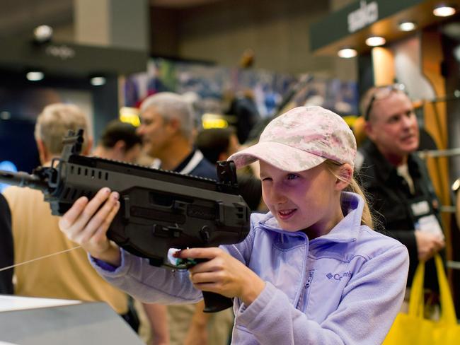 Take aim … Bailey Chappuis, 12, has a go with a Beretta ARX 160 during an NRA meetings last year in St Louis, Missouri. Picture: Whitney Curtis/Getty Images/AFP