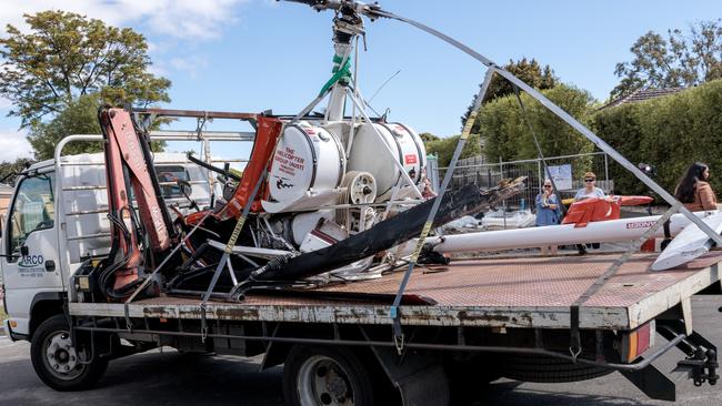Remnants of a helicopter are taken from the crash site in Mentone last year. Picture: NCA NewsWire