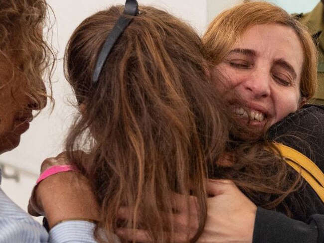 Former hostage Danielle Aloni embraces family members upon her arrival at a hospital in Israel, following her release by Hamas in Gaza with 23 other hostages on November 24, 2023. Picture: AFP/IDF