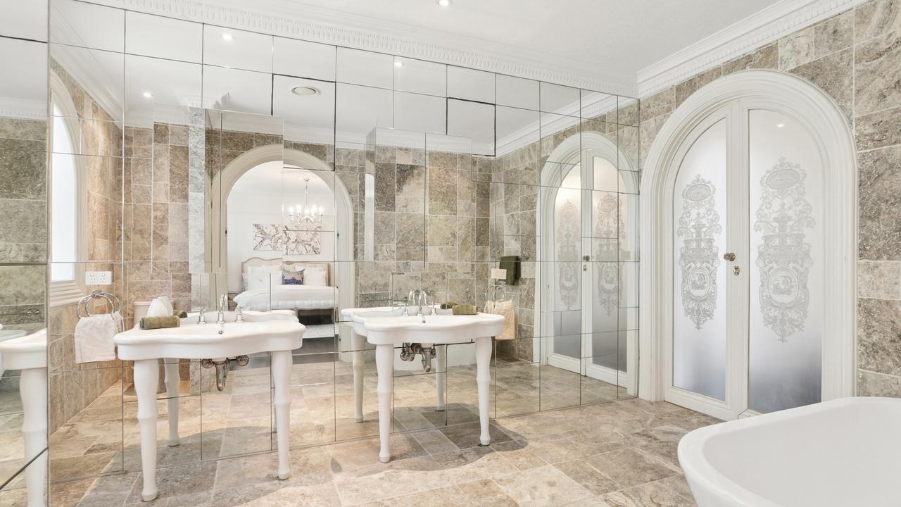 There are four large travertine and mirror bathrooms and three powder rooms.