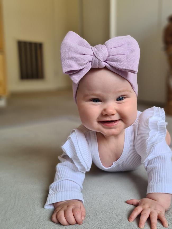 Mackenzie Johnson, seven months old. Mackenzie is a super cheeky and happy baby. She loves animals and singing. She has recently discovered clapping and does this every time she does anything.