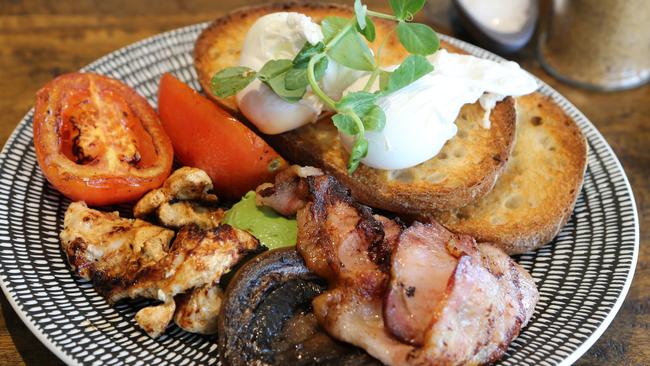 The build-you-own breakfast with bacon, avocado, poached eggs, tomato and sourdough toast. Picture Glenn Hampson