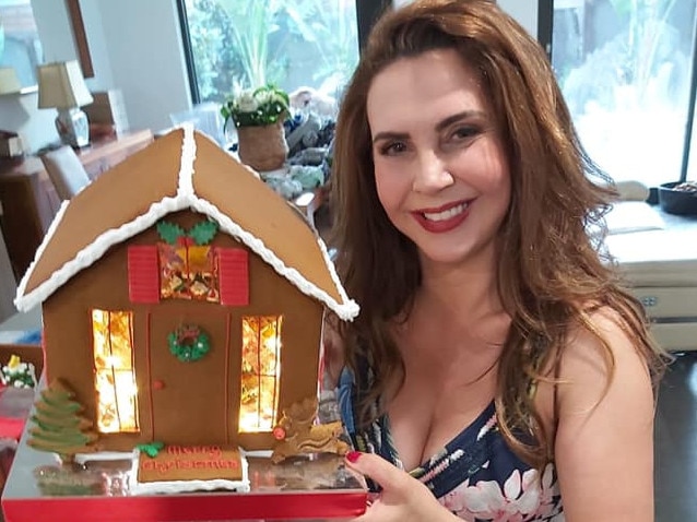 Stonnington mayor Melina Sehr with one of the gingerbead houses made by her business Wonder Ever After. Picture: Facebook