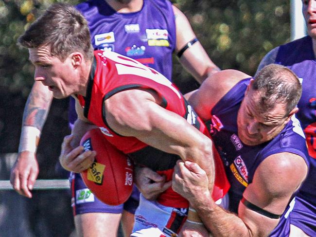 RDFL qualifying final Diggers Rest v Romsey. The Burras Matthew Krul wraps up the Redbacks Matthew Burkett. Picture: Aaron Cook