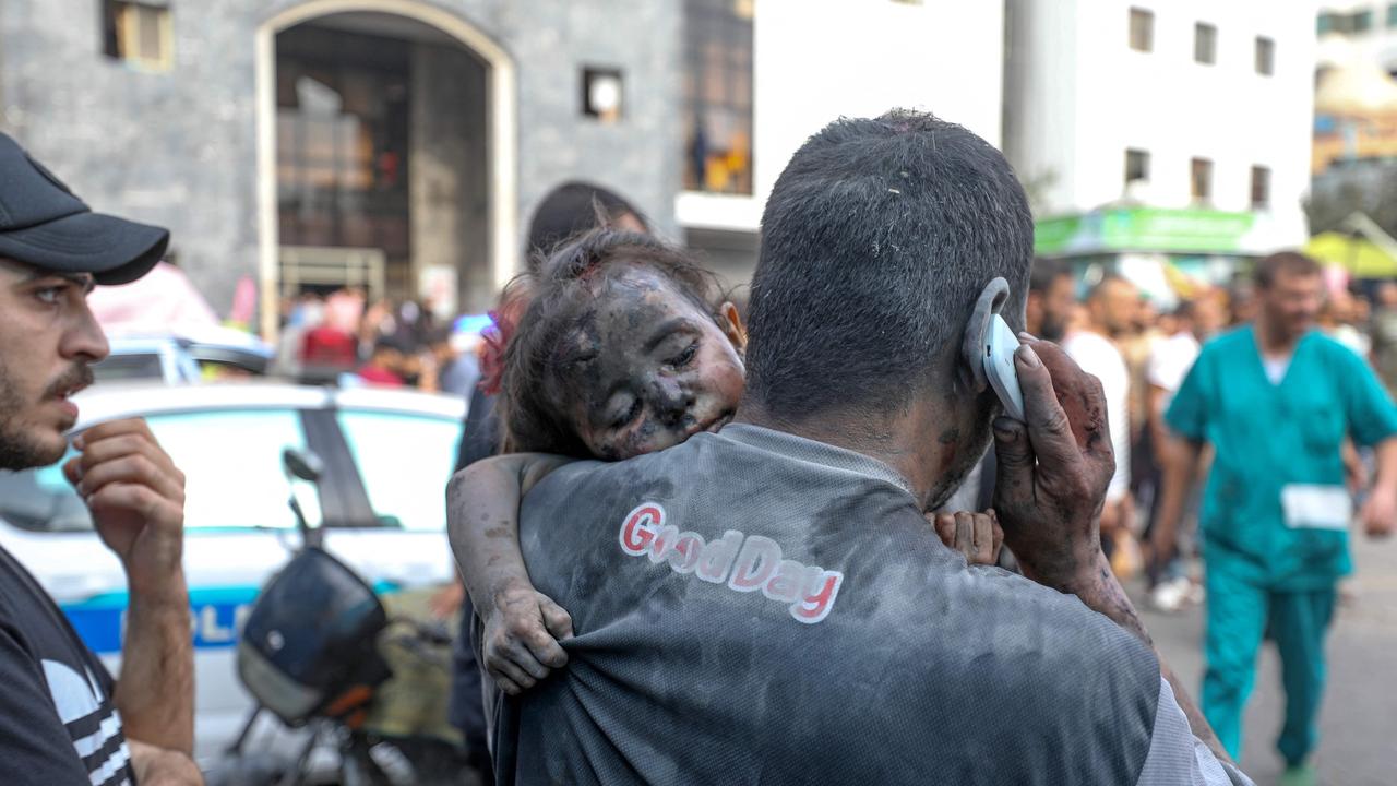 A Palestinian man carries a baby girl into the Al-Shifa hospital in Gaza City. Picture: AFP