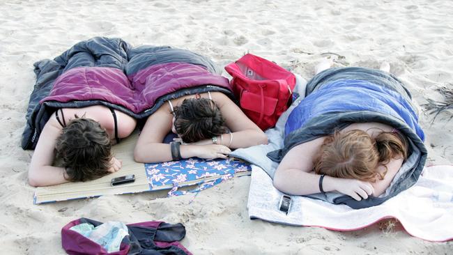 Sara-Jane Camac, Hannah Smith, and Emily Morrow enjoys a snooze on the beach to kick off the new year in 2007. Picture: David Thomas.