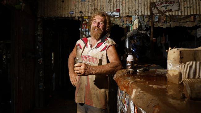 The historic Lion's Den Hotel has survived the largest flood that the Cooktown region has recorded, with the water from the Annan River rising as high as the pub's roof. Lions Den Hotel grounds keeper Craig "Prickles" Thorn, 67, in January enjoyed a cold Great Northern beer at the public bar which is still covered in mud. Picture: Brendan Radke