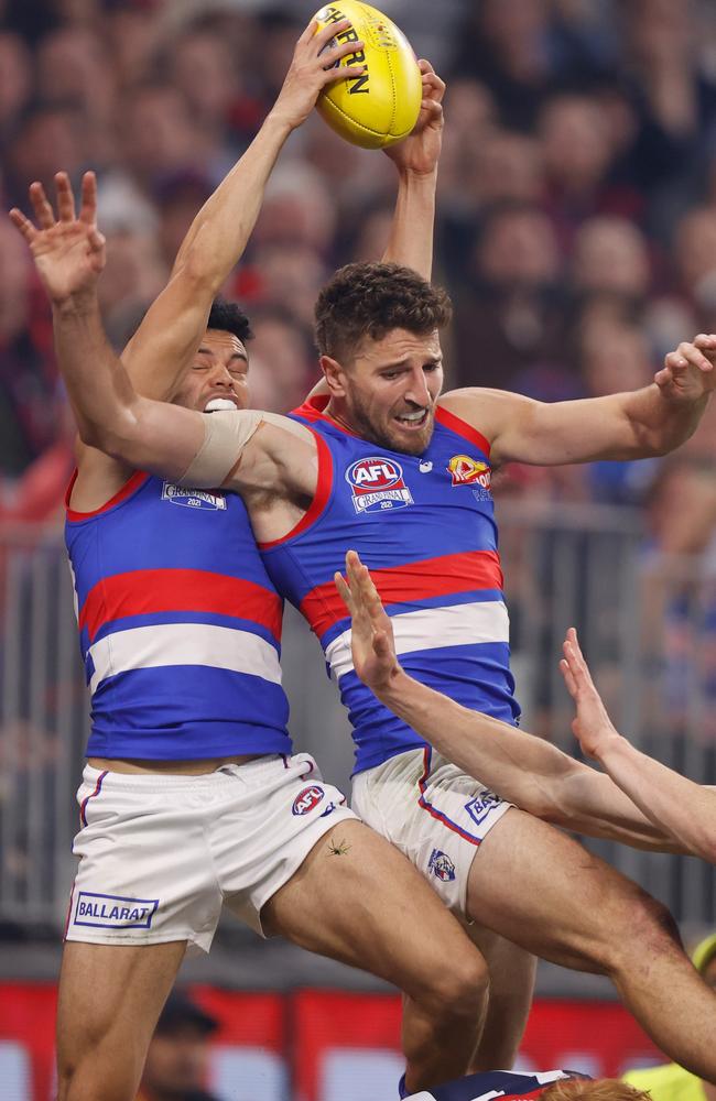 Jason Johannisen takes a high mark over Jake Bowey. Picture: Michael Willson/AFL Photos via Getty Images