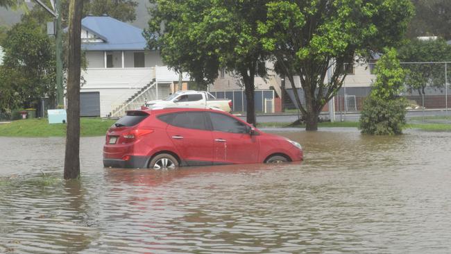 Cars parked at Marie Mackney Courts on Ballina road are inundated by flood water in Lismore for the second time in four weeks Picture: Nicholas Rupolo.