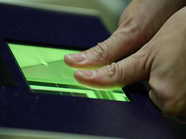 MANCHESTER, ENGLAND - NOVEMBER 16:  Home Office minister Phil Woolas has his fingerprints and photograph scanned as he enrols for the National Identity card at Manchester passport office on November 16, 2009 in Manchester, England. Mr Woolas, regional minister for the North West, is one of the first to enrol for the new biometric identity card which goes live for a trial in Manchester on November 30th.  (Photo by Christopher Furlong/Getty Images)