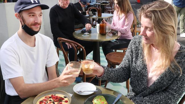 Jim Turner and Michelle Smith enjoy freedom with breakfast at a South Melbourne cafe after a long COVID lockdown. Picture: NCA NewsWire/ David Crosling