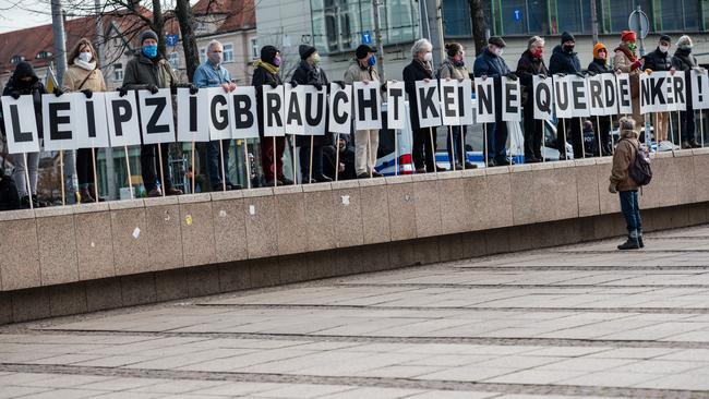 Anti-lockdown protesters with posters saying ‘Leipzig doesn't need lateral thinkers’ in Leipzig, Germany, over the weekend. Picture: Getty Images