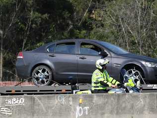 A Holden Commodore crashed on the Bruce Highway at Sippy Downs after a high-speed police chase along the Bruce Highway from Gympie. Photo: Patrick Woods. Picture: Patrick Woods