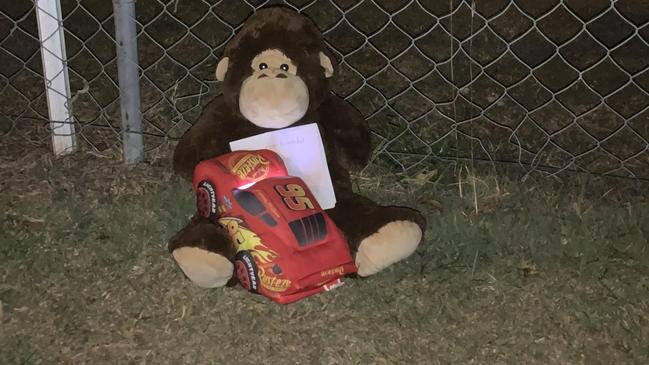 A teddy bear left by a mother and her young sons near were two baby girls were found dead in a car near Brisbane. Picture: Patrick Billings