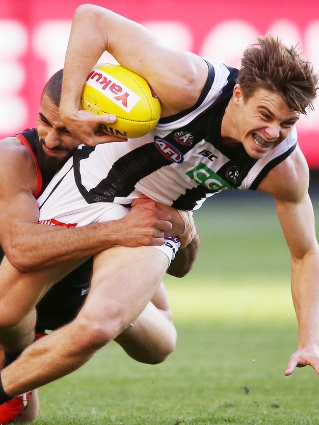 Adam Saad puts the clamps on Collingwood forward Josh Thomas on Anzac Day. Picture: Michael Dodge/Getty Images.