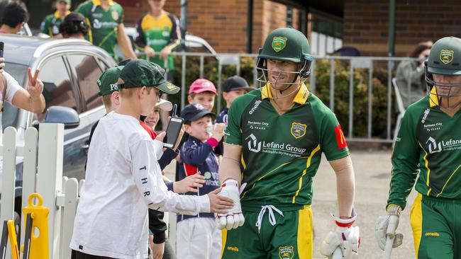 David Warner is greeted by fans as he makes his way on to the field to bat during of grade cricket game between Randwick Petersham and St George at Coogee Oval