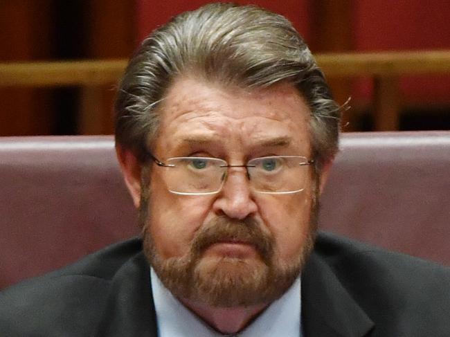 Justice Party Senator Derryn Hinch listens as Minister for Finance Senator Mathias Cormann addresses the Senate chamber at Parliament House in Canberra, Tuesday, March 27, 2018. (AAP Image/Mick Tsikas) NO ARCHIVING