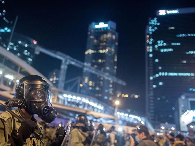 Riot police stand guard outside of Hong Kong Government Building. Pic: AP.